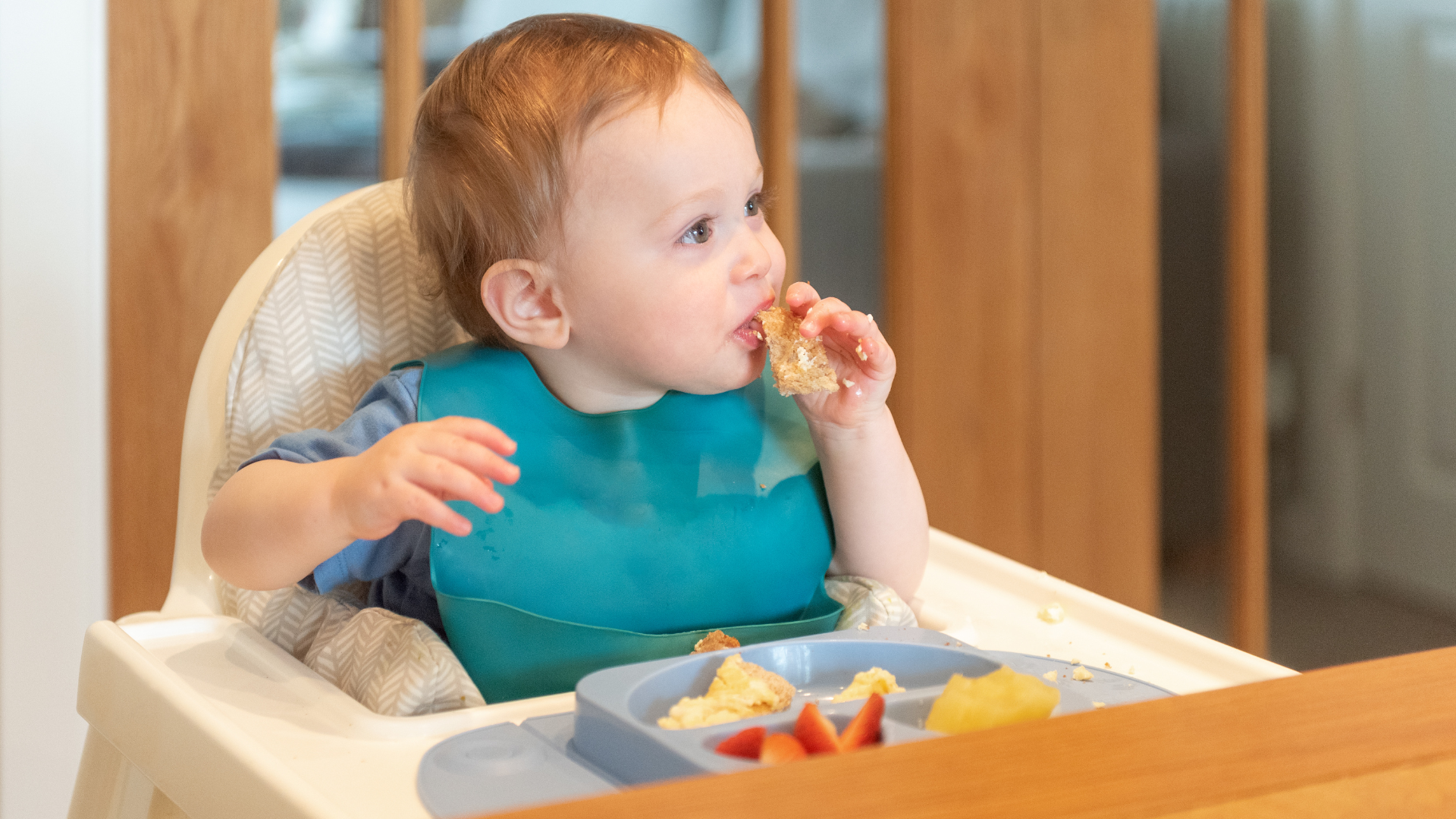 Baby experiencing Baby-Led Weaning by independently eating