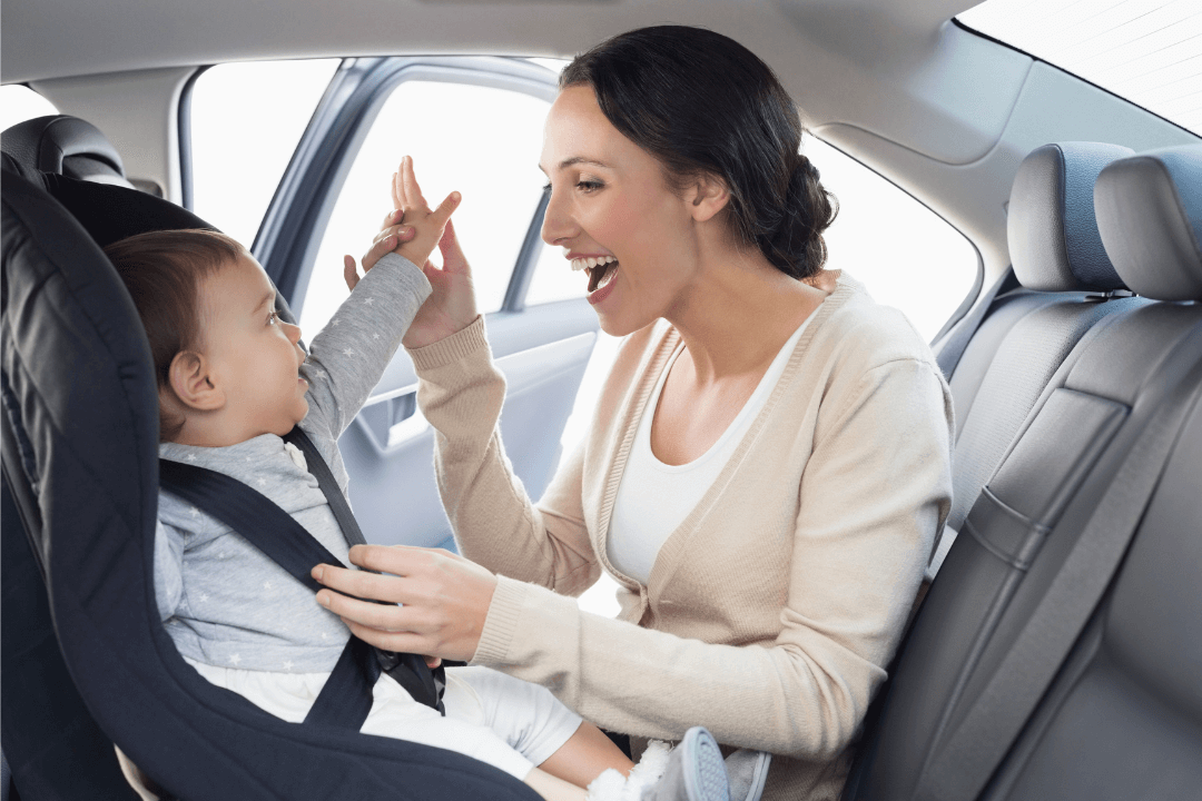 A mother and her baby in car seat 